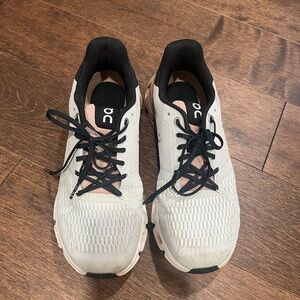 On Running White and Black Athletic Shoes